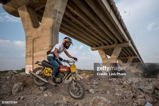 Le Viet Bach, 26 - a Minsk motorcycle enthusiast, pratices new tricks on the dirt tracks in preparation for an off-road tournament on the following...