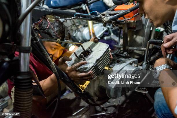 Pham Ngoc Thach, 27 - a Minsk motorcycle enthusiast turned into professional engineer, fine-tunes his own Minsk motorcycle in preparation for an...