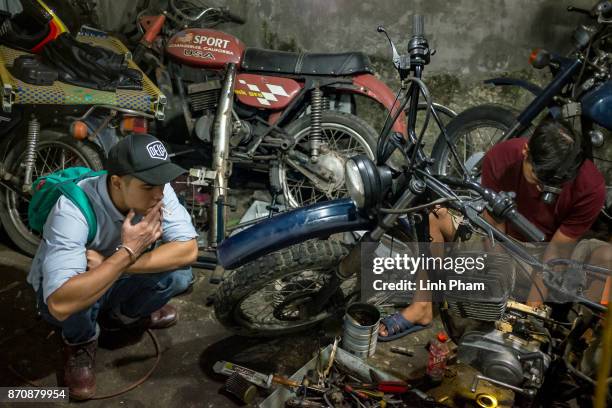 Pham Ngoc Thach, 27 - a Minsk motorcycle enthusiast turned into professional engineer, fine-tunes his own Minsk motorcycle in preparation for an...