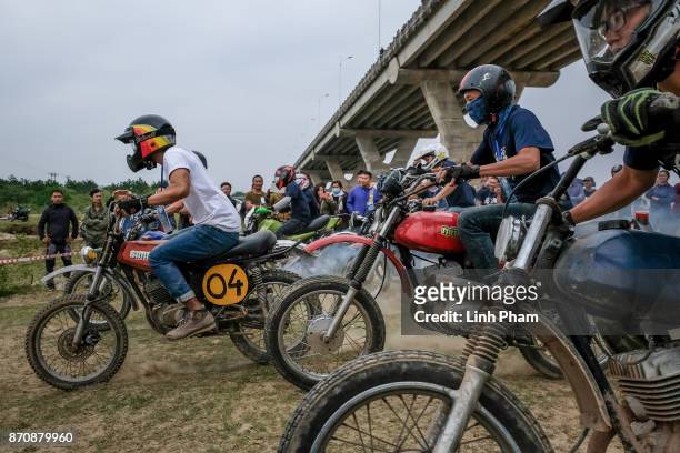 Minsk motorcyclists race at a dirt track on November 5, 2017 in Hanoi, Vietnam. A new generation of Vietnamese have started to ply the roads across...