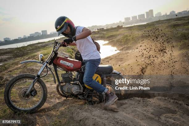 Le Viet Bach, 26 - a Minsk motorcycle enthusiast, pratices new tricks on the dirt tracks in preparation for an off-road tournament on the following...