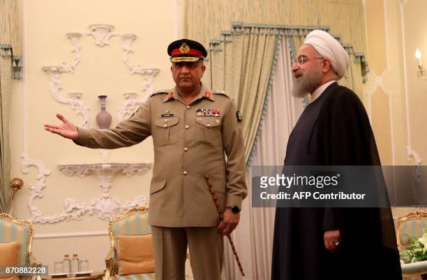 Iranian President Hassan Rouhani meets with Pakistan Army Chief General Qamar Javed Bajwa in Tehran on November 6, 2017. / AFP PHOTO / ATTA KENARE