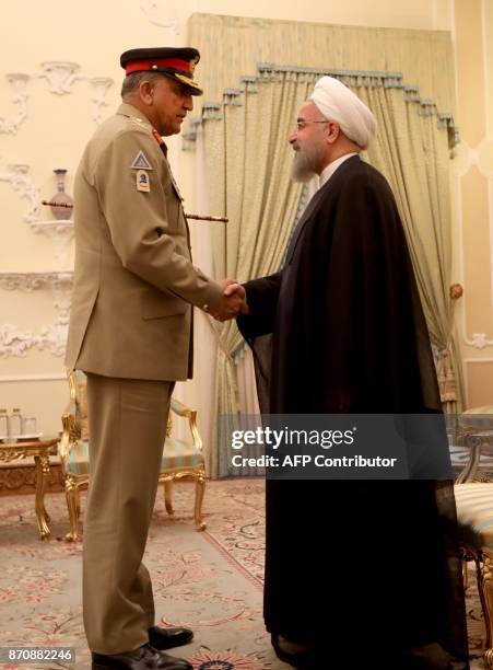 Iranian President Hassan Rouhani meets with Pakistan Army Chief General Qamar Javed Bajwa in Tehran on November 6, 2017. / AFP PHOTO / ATTA KENARE