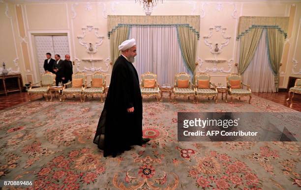 Iranian President Hassan Rouhani arrives to meet with Pakistan Army Chief General Qamar in Tehran on November 6, 2017. / AFP PHOTO / ATTA KENARE