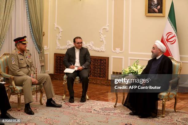 Iranian President Hassan Rouhani meets with Pakistan Army Chief General Qamar Javed Bajwa in Tehran on November 6, 2017. / AFP PHOTO / ATTA KENARE