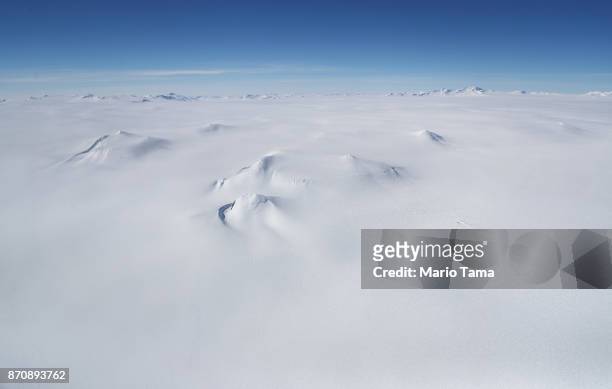 Mountains are mostly covered in ice as seen from NASA's Operation IceBridge research aircraft, in the Antarctic Peninsula region, on November 3 above...