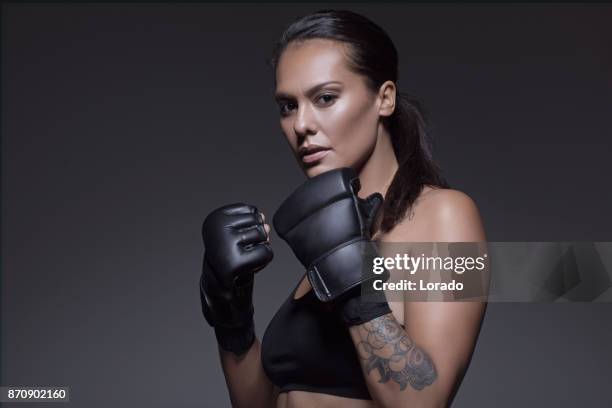 beautiful brunette female fighter posing for potrait - mixed martial arts stock pictures, royalty-free photos & images