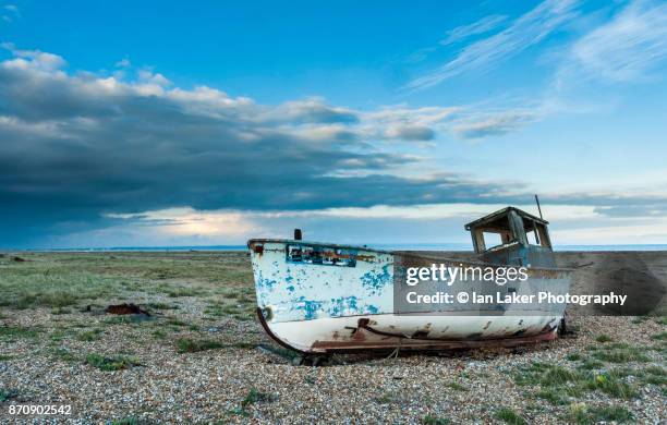 boat on dungeness beach, kent, uk. - abandoned boat stock pictures, royalty-free photos & images