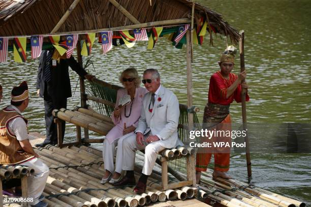 Prince Charles, Prince of Wales and Camilla, Duchess of Cornwall ride on a traditional raft across a lake as they leave after a visit to Sarawak...