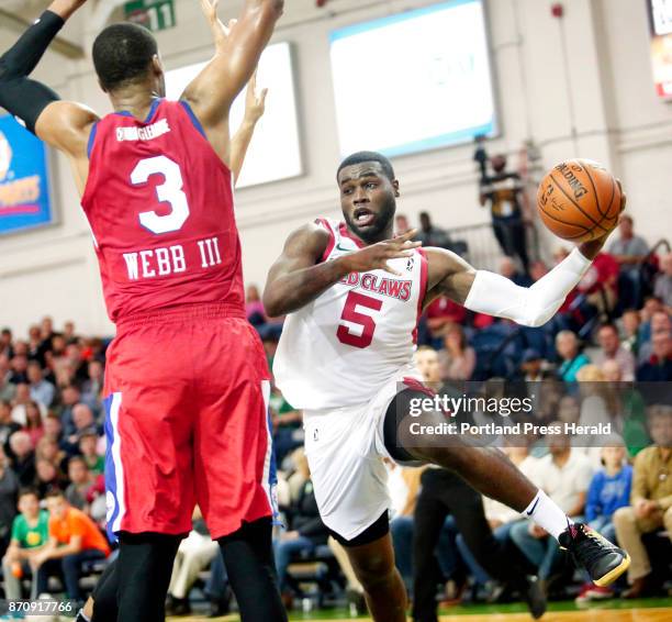 Maine Red Claws vs Delaware 87ers. Kadeem Allen of Maine dishes the ball around James Webb III of Delaware after driving to the basket in the third...
