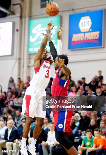 Maine Red Claws vs Delaware 87ers. Daniel Dixon of Maine shoots a three-point shot over Mike Young of Delaware in the third period.