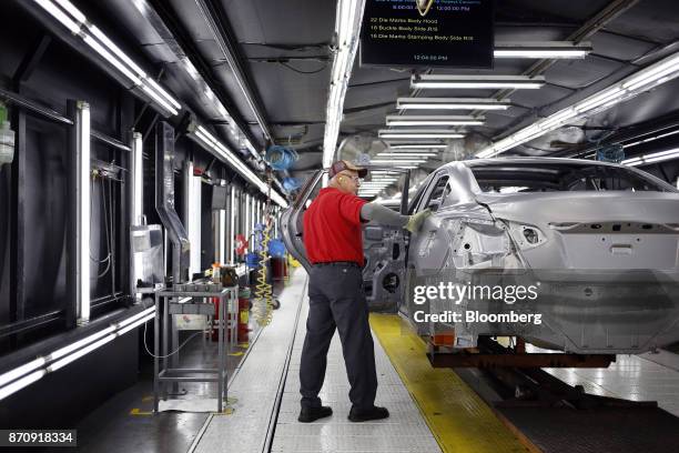 Worker inspects vehicle frames on the assembly line at the Nissan Motor Co. Manufacturing facility in Smyrna, Tennessee, U.S., on Tuesday, Oct. 31,...