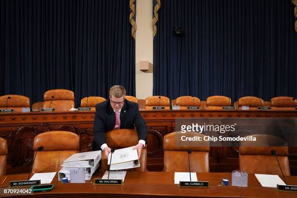 House Ways and Means Committee majority staff member Thomas Kutz delivers copies of the proposed GOP tax reform legislation before a markup session...