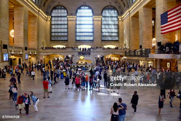 Tourists and travelers fill the Main Concourse of Grand Central Terminal in New York, New York. The Midtown Manhattan landmark is a commuter, rapid...