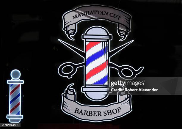 Rendering of an iconic barber's pole is painted on the front window of a barber shop in Midtown Manhattan, New York City.