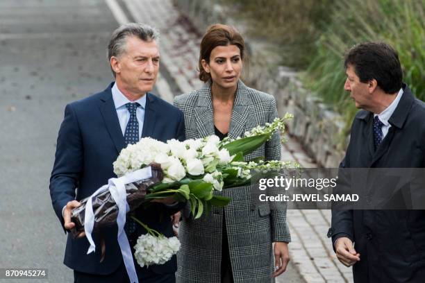 Argentina's Presidnet Mauricio Macri and Frist Lady Juliana Awada arrive to lay a wreath on a bike path during a ceremony in New York on November 6...