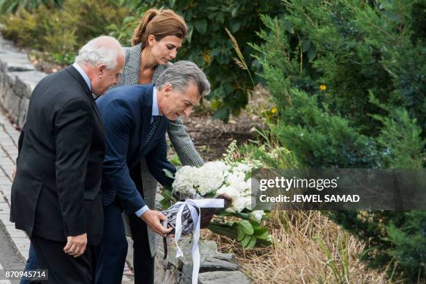 Argentina's Presidnet Mauricio Macri , Frist Lady Juliana Awada and Santa Fe Governor Miguel Lifschitz lay a wreath on a bike path during a ceremony...