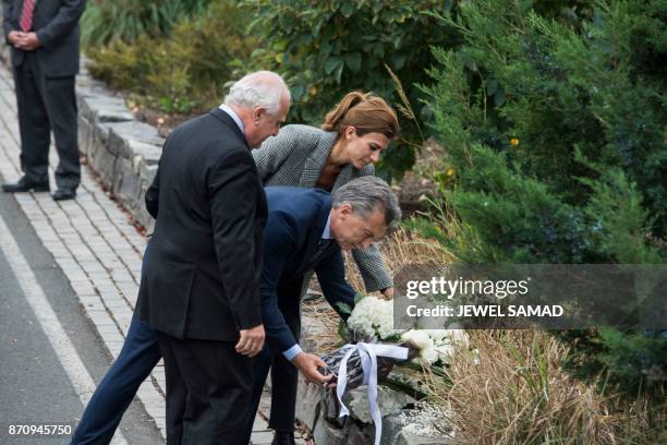 Argentina's Presidnet Mauricio Macri , Frist Lady Juliana Awada and Santa Fe Governor Miguel Lifschitz lay a wreath on a bike path during a ceremony...