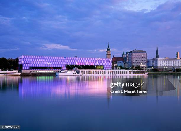 panorama of linz and the danube river at dusk - linz stock-fotos und bilder