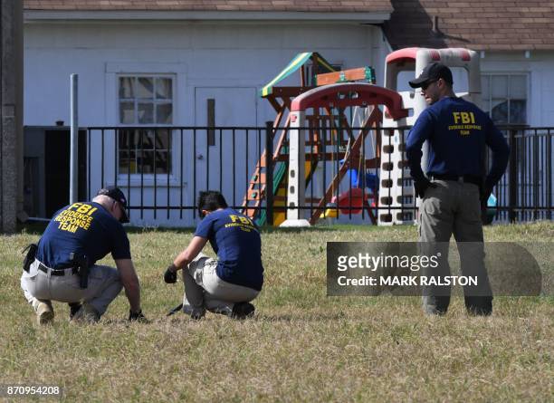 Agents search for clues at the entrance to the First Baptist Church, after a mass shooting that killed 26 people in Sutherland Springs, Texas on...