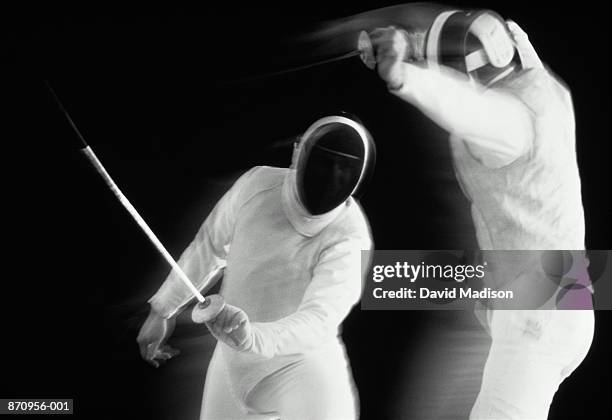 fencing, competitor lunging at opponent (b&w) - mask confrontation stock pictures, royalty-free photos & images