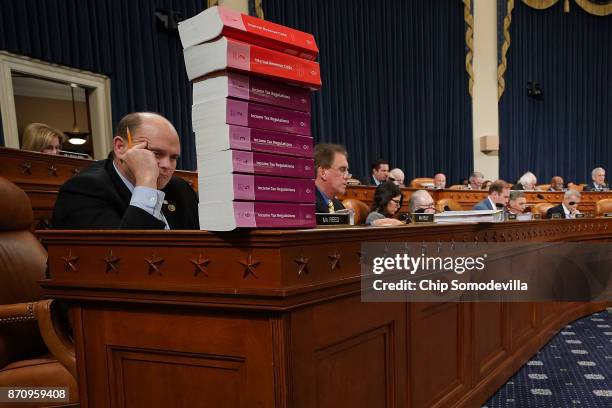House Ways and Means Committee member Rep. Tom Reed keeps a stack of books that document the current federal tax code and related regulations on his...