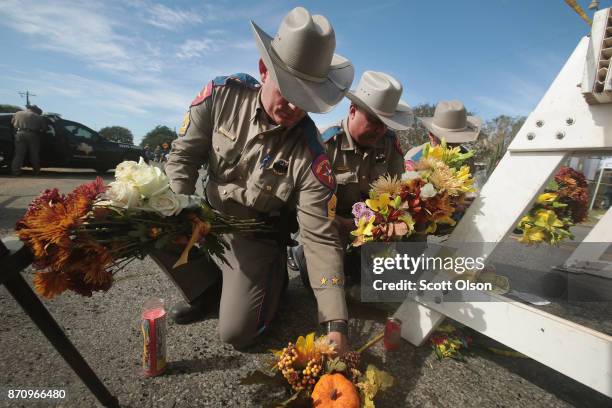 Police move flowers placed at a barricade near the First Baptist Church of Sutherland Springs on November 6, 2017 in Sutherland Springs, Texas....