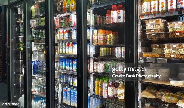 products on display in store window of a grocery store in the east village, new york city - grocery store window stock pictures, royalty-free photos & images