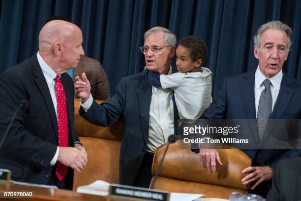 Chairman Kevin Brady, R-Texas, left, greets Rep. Earl Blumenauer, D-Ore., and his grandson, Quinn, during for a House Ways and Means Committee markup...