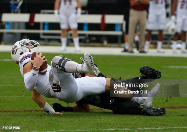 Ross Comis of the Massachusetts Minutemen is sacked by Montez Sweat of the Mississippi State Bulldogs during the first half of an NCAA football game...