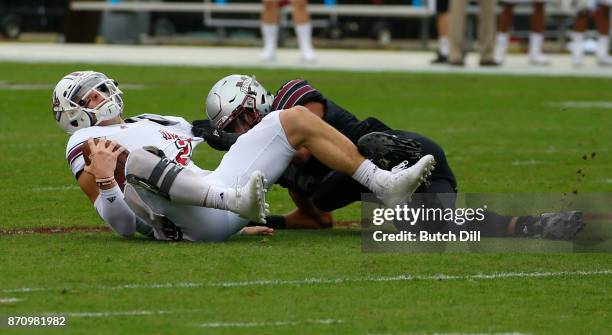 Ross Comis of the Massachusetts Minutemen is sacked by Montez Sweat of the Mississippi State Bulldogs during the first half of an NCAA football game...