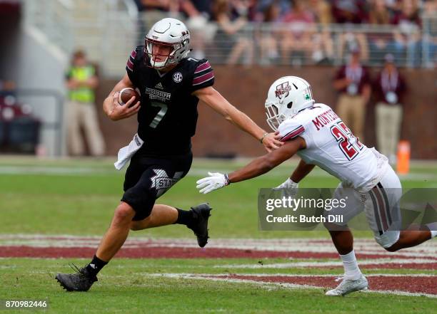 Nick Fitzgerald of the Mississippi State Bulldogs carries the ball around Jesse Monteiro of the Massachusetts Minutemen during the second half of an...