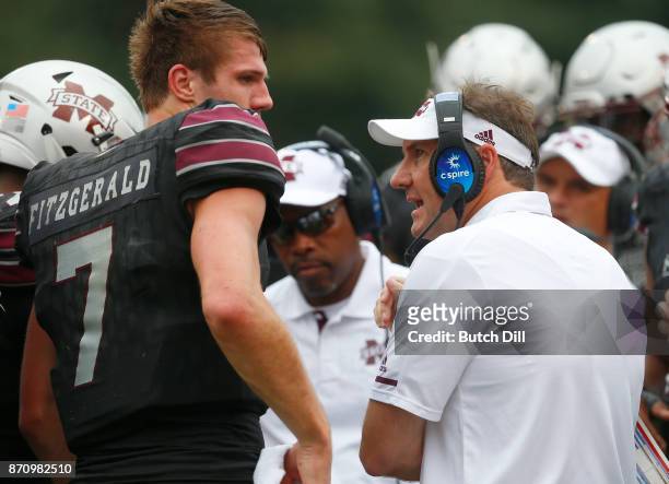 Head coach Dan Mullen of the Mississippi State Bulldogs talks with Nick Fitzgerald during the second half of an NCAA football game against the...