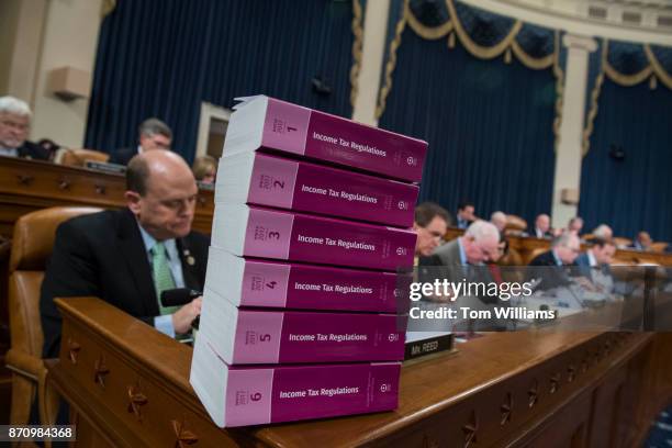 Stack of the current income tax regulations sits on the dais during a House Ways and Means Committee markup of the Republicans' tax reform plan...