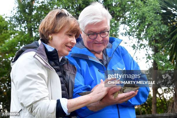 German President Walter Steinmeier with his wife Elke Budenbender hold a Tuatara called Tane at Zealandia wildlife park in Wellington on November 7,...