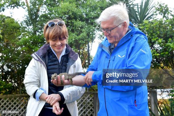 German President Walter Steinmeier with his wife Elke Budenbender hold a Tuatara called Tane at Zealandia wildlife park in Wellington on November 7,...
