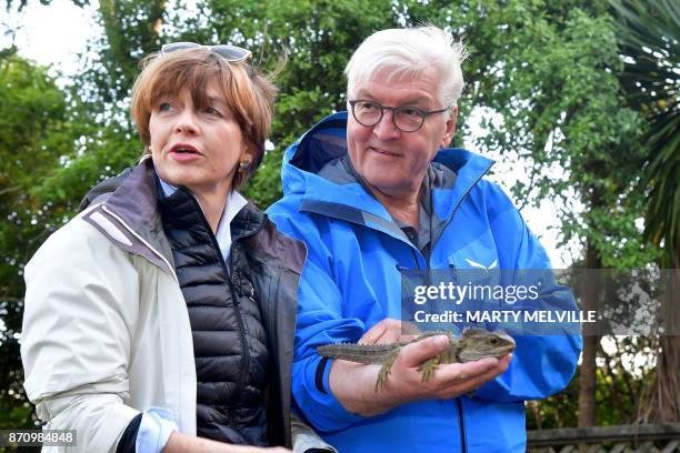 German President Walter Steinmeier with his wife Elke Budenbender hold a Tuatara called Tane at Zealandia wildlife park in Wellington on November 7,...