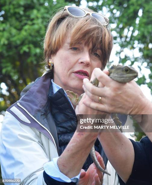 Elke Budenbender wife of German President Walter Steinmeier holds a Tuatara called Tane at Zealandia wildlife park in Wellington on November 7, 2017....