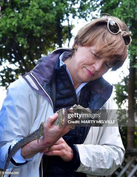 Elke Budenbender wife of German President Walter Steinmeier holds a Tuatara called Tane at Zealandia wildlife park in Wellington on November 7, 2017....