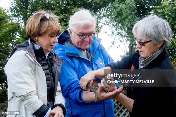 German President Walter Steinmeier with his wife Elke Budenbender hold a Tuatara with keeper Sue Lum at Zealandia wildlife park in Wellington on...
