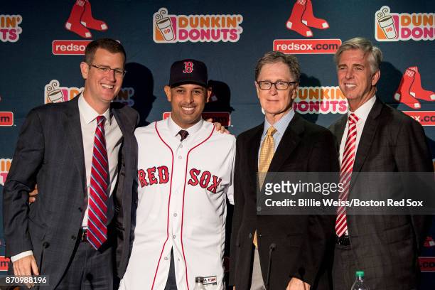 Alex Cora shakes hands with Boston Red Sox President & CEO Sam Kennedy, Boston Red Sox Principal Owner John Henry, and Boston Red Sox President of...