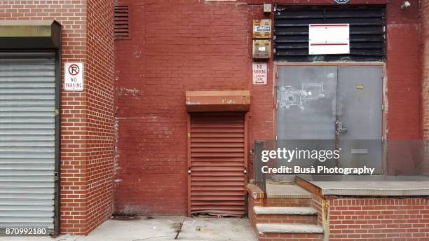 garage roll-down grates along carlton avenue in brooklyn, new york city - alley fotografías e imágenes de stock