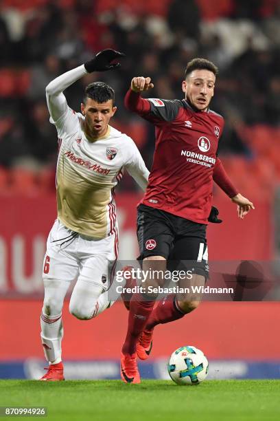Alfredo Morales of FC Ingolstadt 04 and Kevin Moehwald of 1.FC Nuernberg compete for the ball during the Second Bundesliga match between 1. FC...