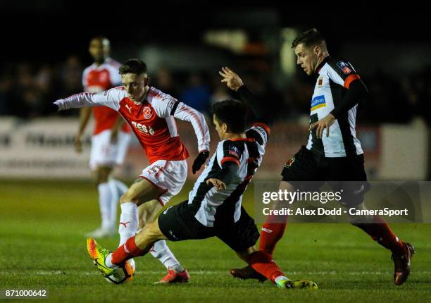 Fleetwood Town's Ashley Hunter is tackled by Chorley's Stephen Jordan during the FA Cup First Round match between Chorley v Fleetwood at Victory Park...