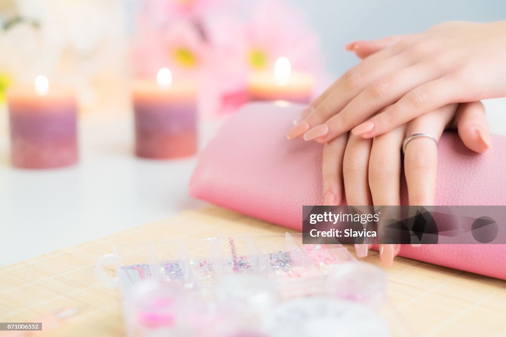 Perfect artificial fingernails of young woman