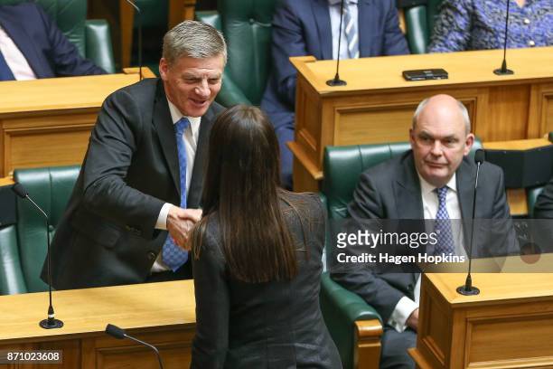 Prime Minister Jacinda Ardern and former Prime Minister Bill English shake hands while National MP Steven Joyce looks on during the Commission...