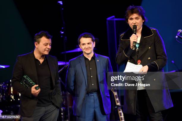 James Dean Bradfield, Sean Moore and Nicky Wire of the Manic Street Preachers speak on stage at the 26th annual Music Industry Trust Awards held at...