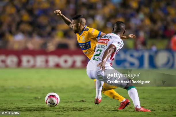 Javier Aquino of Tigres fights for the ball with Brayan Beckeles of Necaxa during the 16th round match between Tigres UANL and Necaxa as part of the...