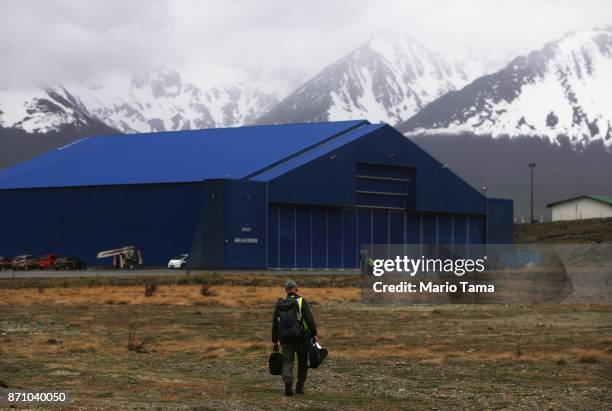 Operation IceBridge mission scientist John Sonntag walks to the hangar, following a long science flight, aboard NASA's research aircraft in the...