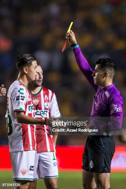 Referee Adonai Escobedo gives a red card to Roberto Alvarado of Necaxa during the 16th round match between Tigres UANL and Necaxa as part of the...